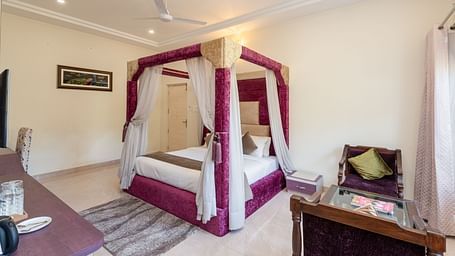 Luxurious bedroom at DLS Tehri Club Resort with a four-poster bed and elegant decor